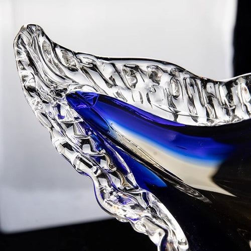 Close up detail of the textured scalloped glass rim and blue hue