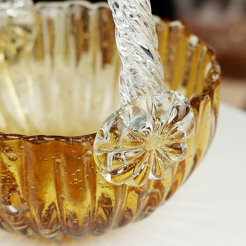 Close up detail of amber bubble glass texture and clear twisted handle with floral rosette