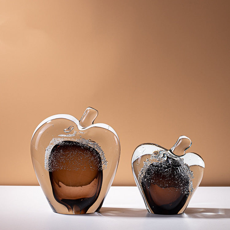 Two amber art glass apple sculptures with bubble detailing