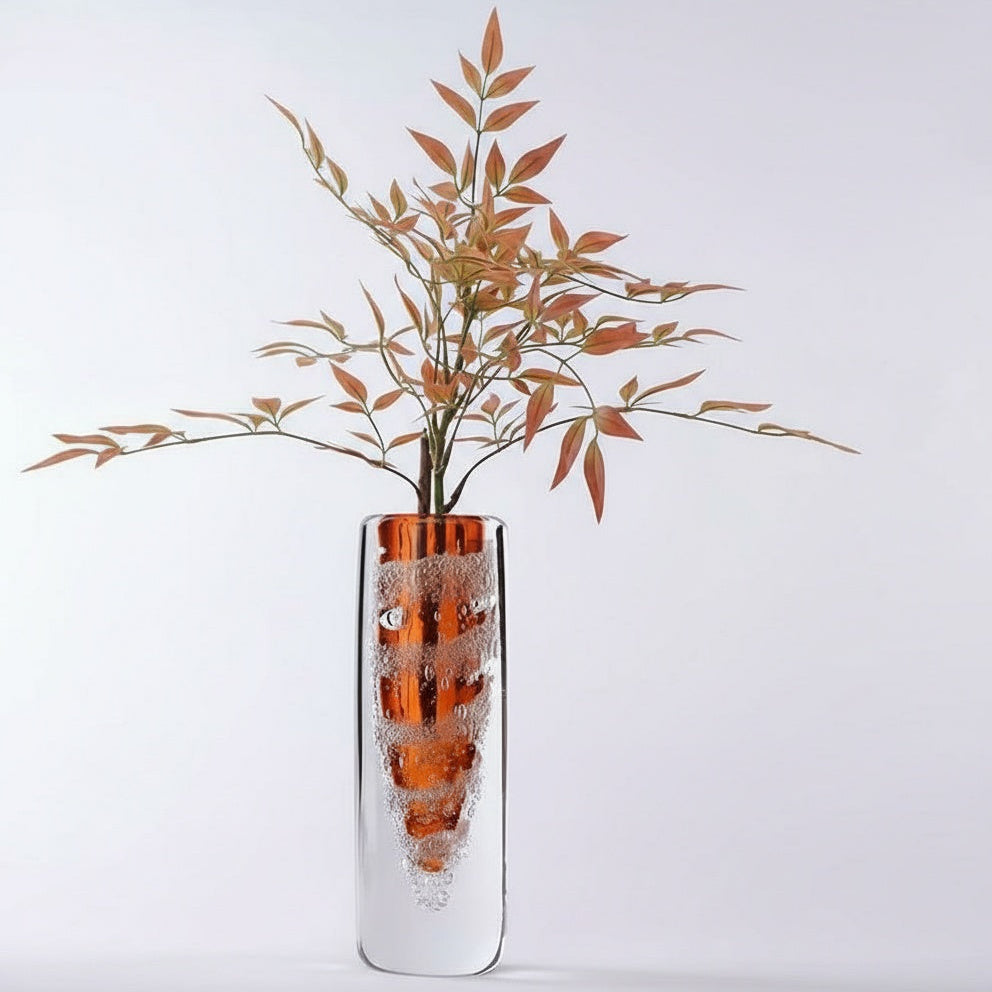 Large amber glass vase with floral arrangement