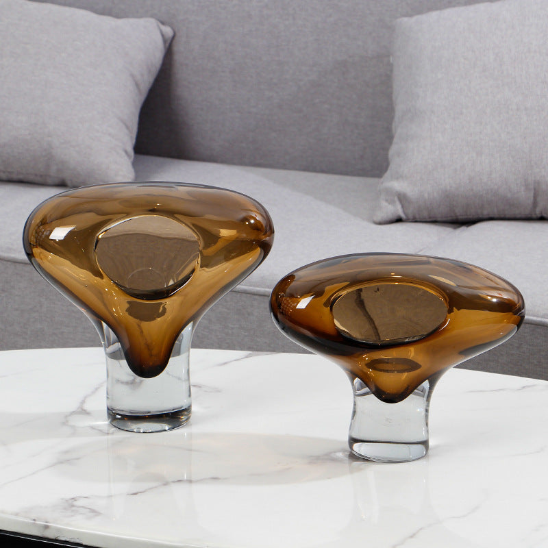 Amber and clear glass sculptural vases set on marble table