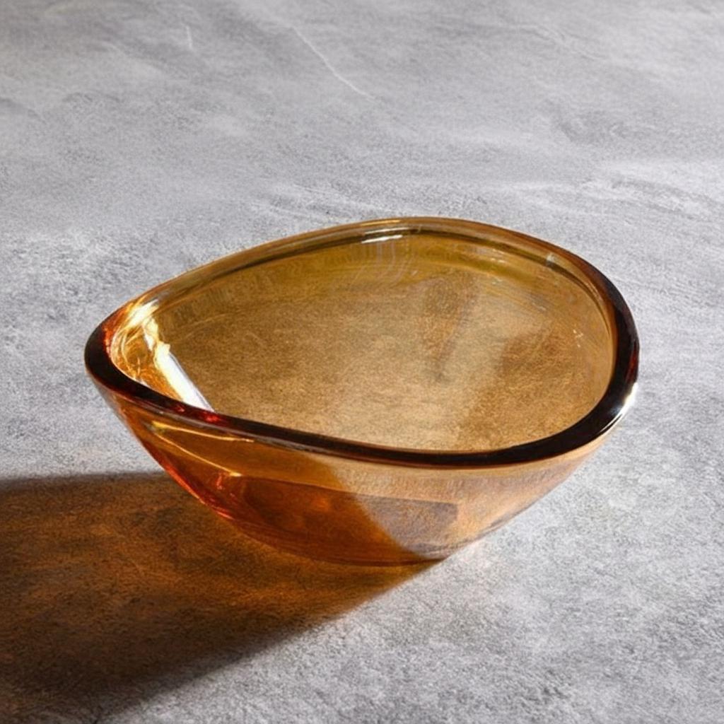 Angled top view of empty amber glass bowl showing transparency