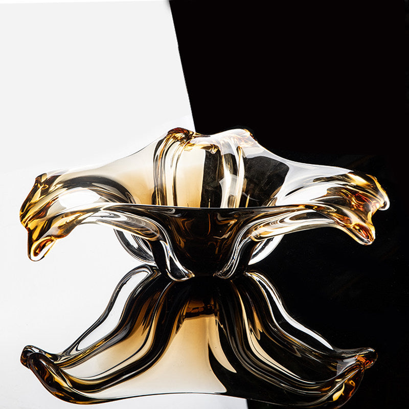 Reflection of amber glass bowl on black surface