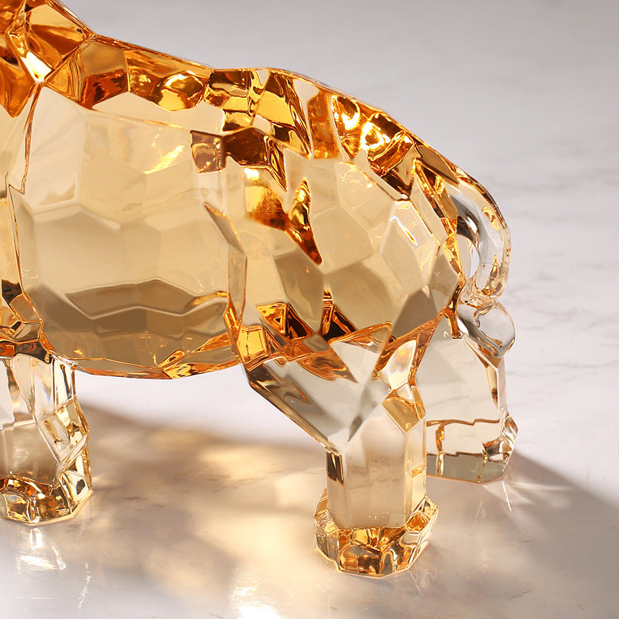 Rear detail of amber faceted rhino sculpture showing light refraction