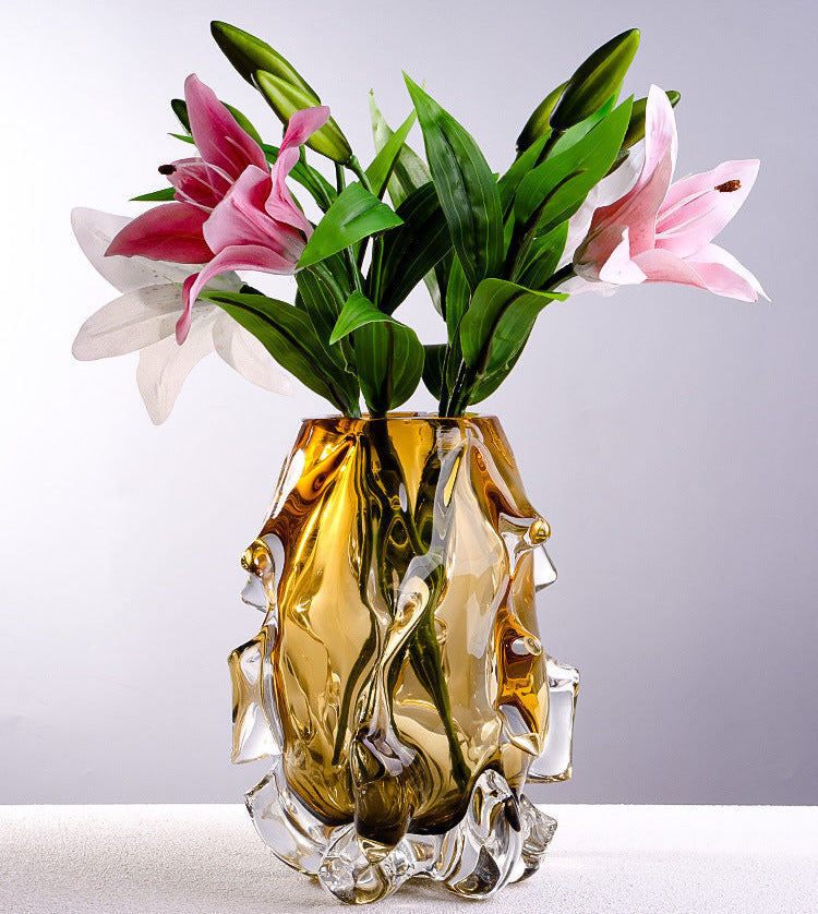 Amber crystal vase with pink lilies on table