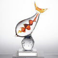 Front view of clear glass fish sculpture with amber spiral core