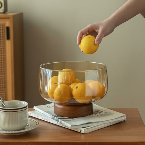 Amber Glass And Wood Pedestal Bowl holding fresh fruit