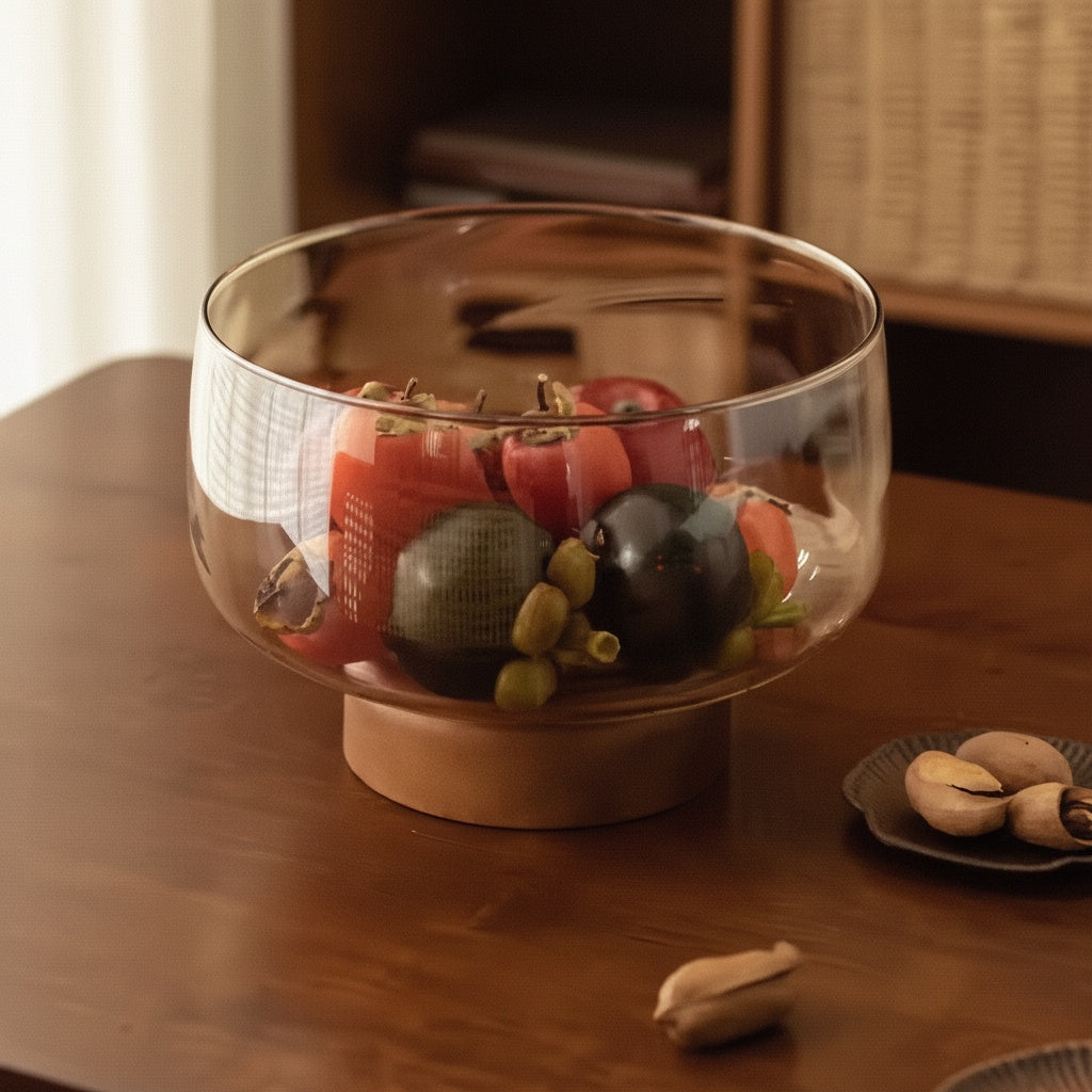 Close up of Amber Glass And Wood Pedestal Bowl on a wooden table