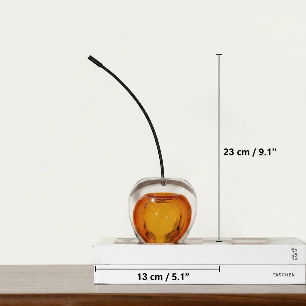 Top down view of two glass cherry sculptures