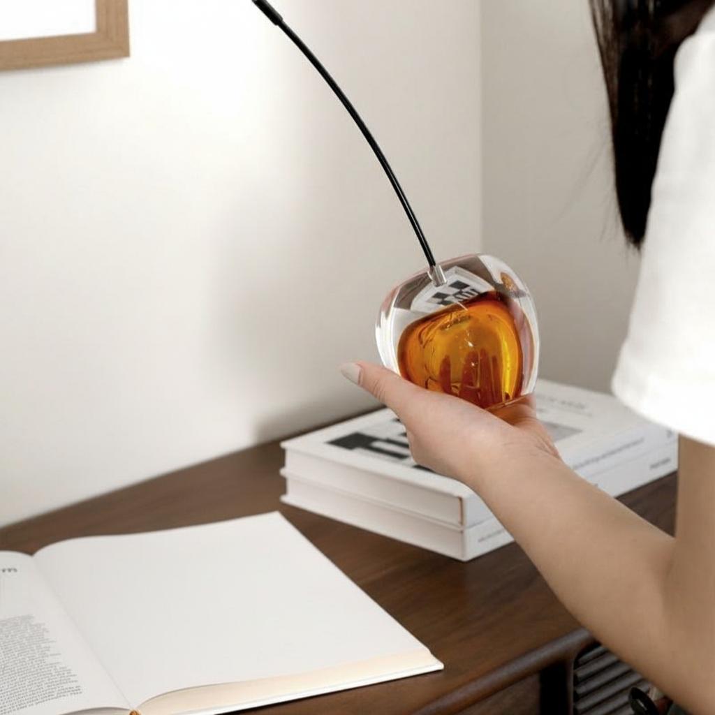 Close up of amber glass cherry on white surface