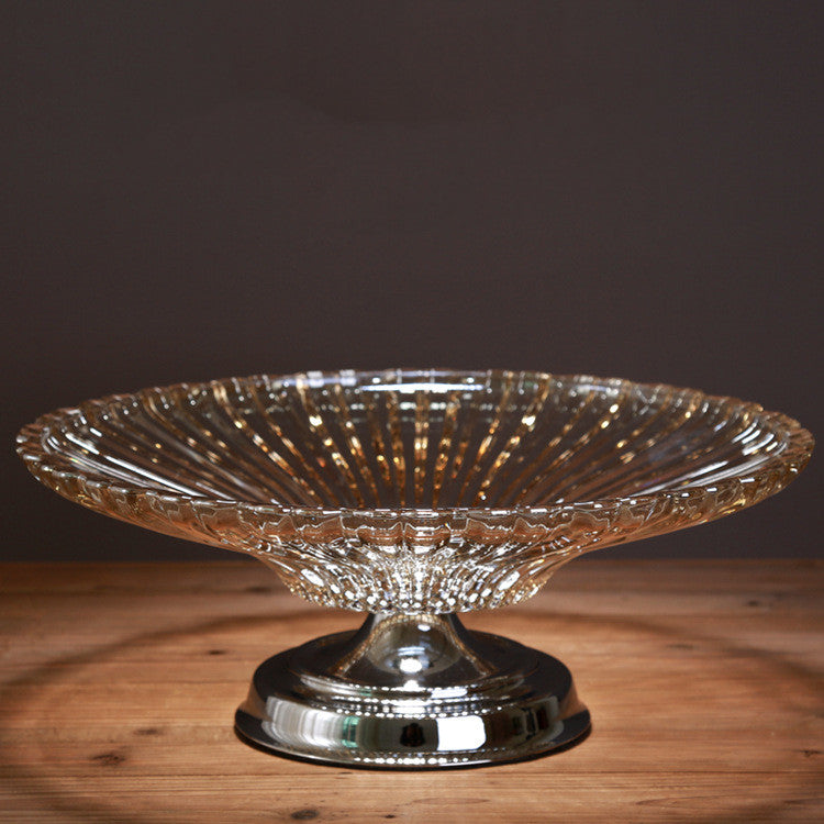 Front view of amber glass ribbed fruit bowl on chrome pedestal