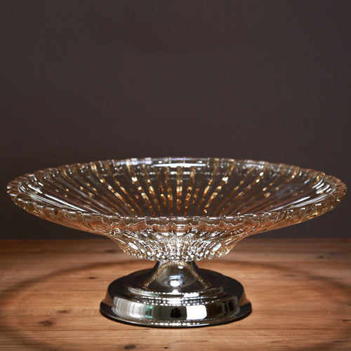 Front view of amber glass ribbed fruit bowl on chrome pedestal