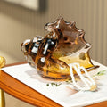 Amber Glass Conch Shell Decorative Bowl holding pearls