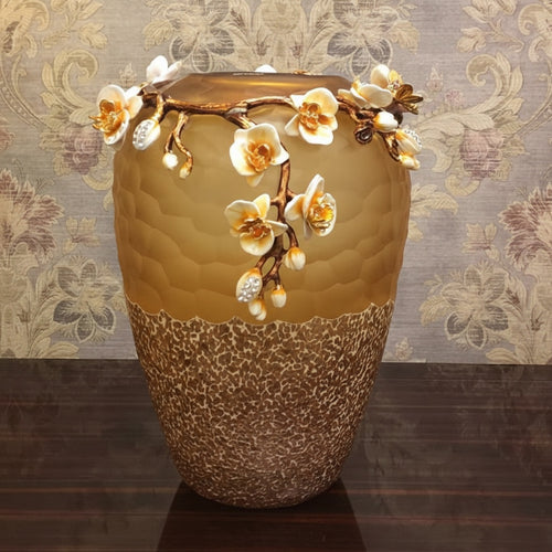 Detail view of floral accents on amber vase