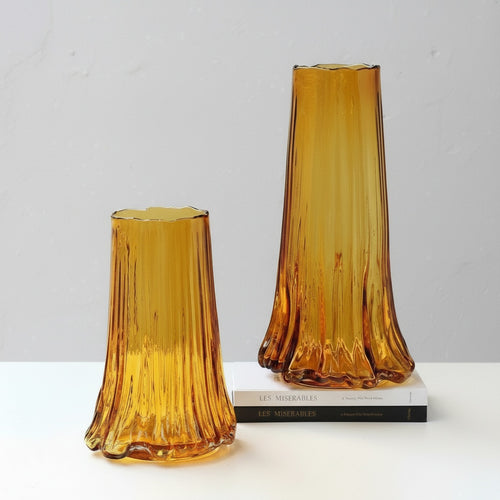 Amber glass vase with fluted texture and wavy base styling