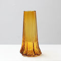 Large amber glass vase with fluted details and undulating base design