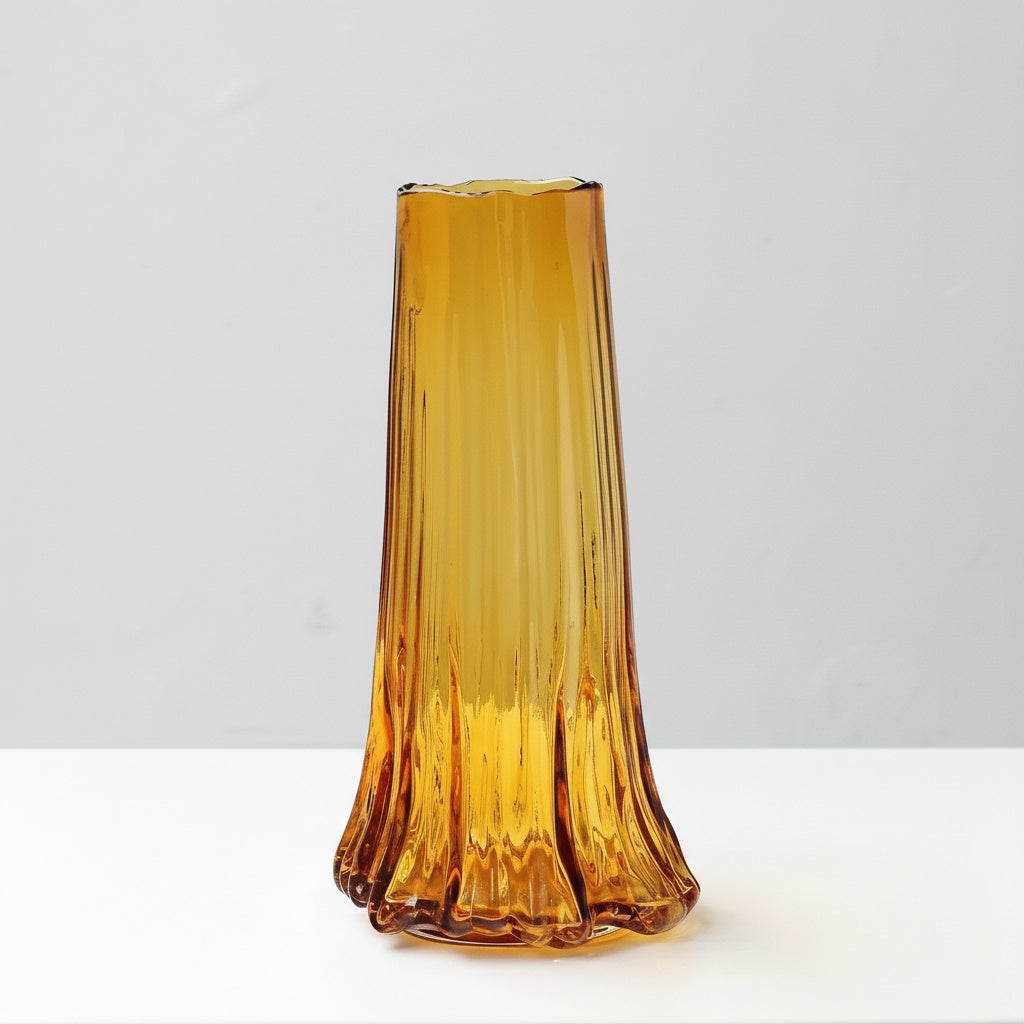 Large amber glass vase with fluted details and undulating base design
