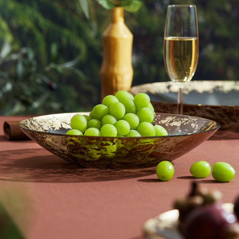 Side profile of gold leaf glass bowl filled with fruit