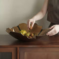 Amber glass and gold wavy centerpiece bowl held by hands