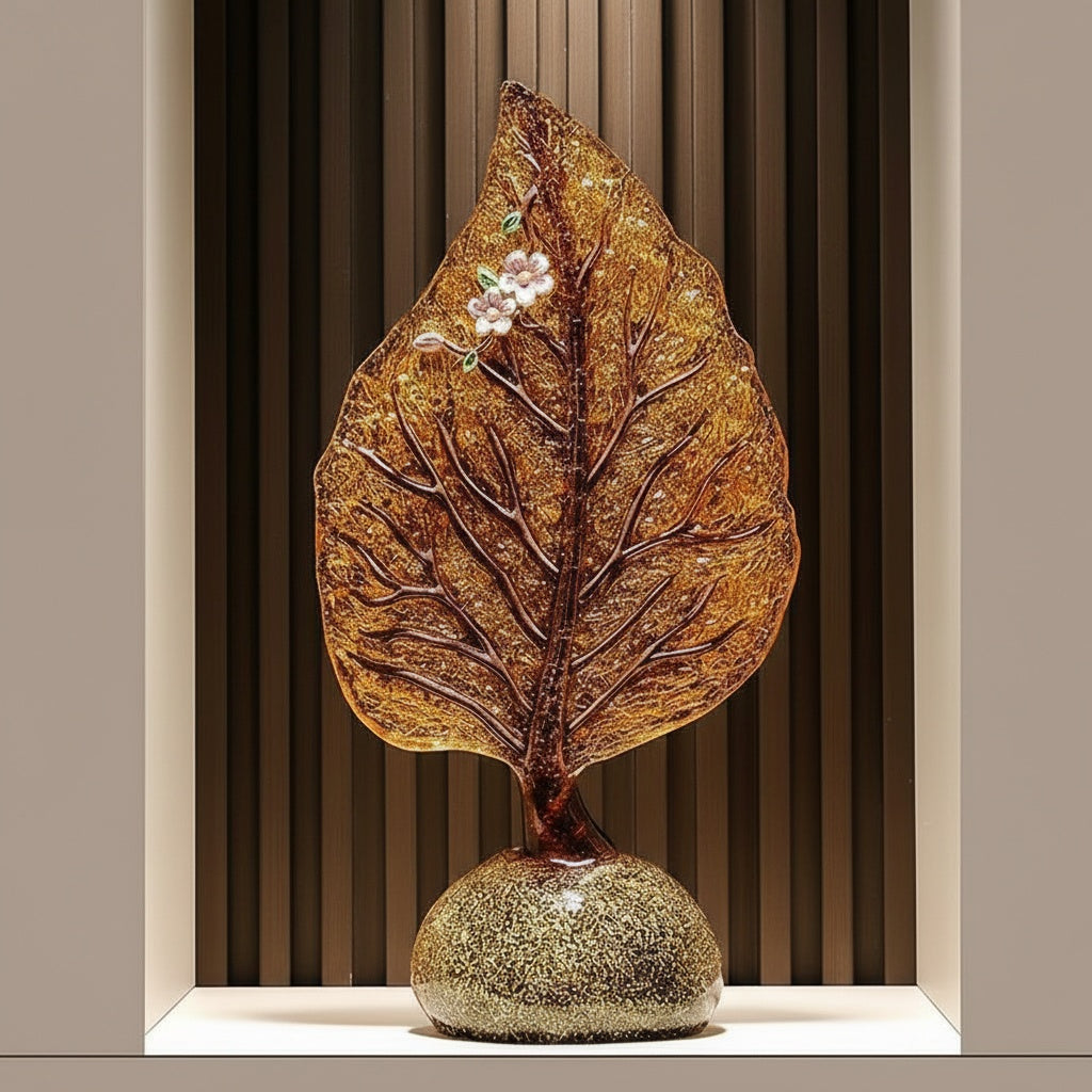 Amber glass leaf sculpture displayed in a luxury niche