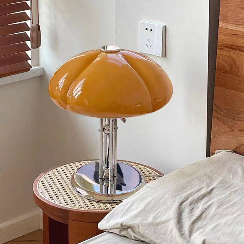 Side view of amber glass table lamp on rattan side table