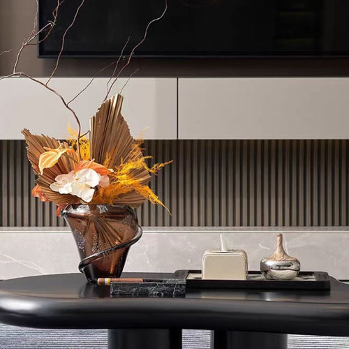 Medium amber glass vase on luxury coffee table with dried flowers