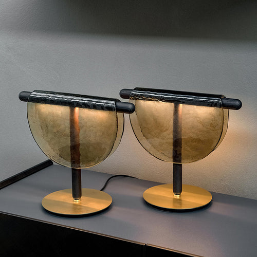 Front view of two amber glass t-bar table lamps lit up