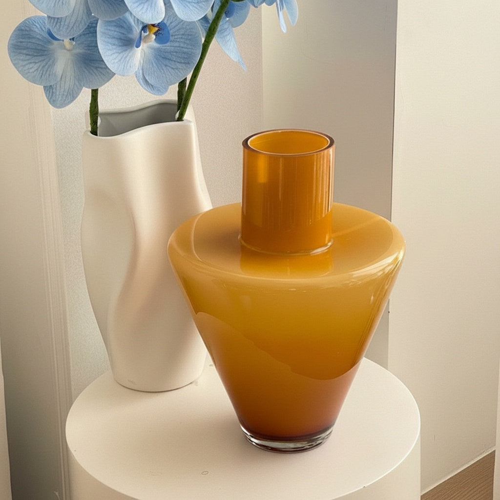 Top angle view of orange glass tapered vase
