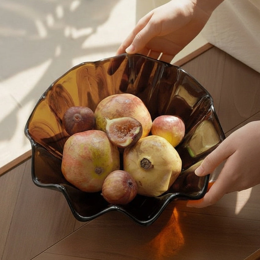 High angle view of amber glass wavy fruit bowl with fruit on table