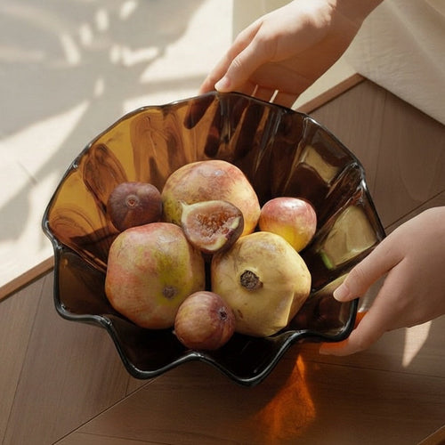 High angle view of amber glass wavy fruit bowl with fruit on table