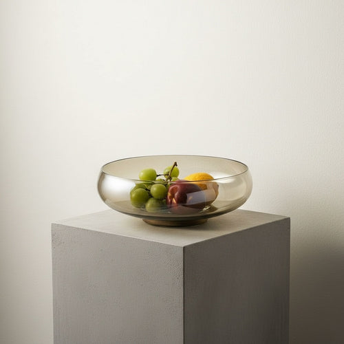 High angle view of amber glass bowl on wood stand
