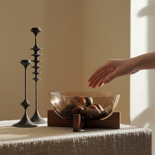 Amber glass bowl centerpiece on table next to candlesticks