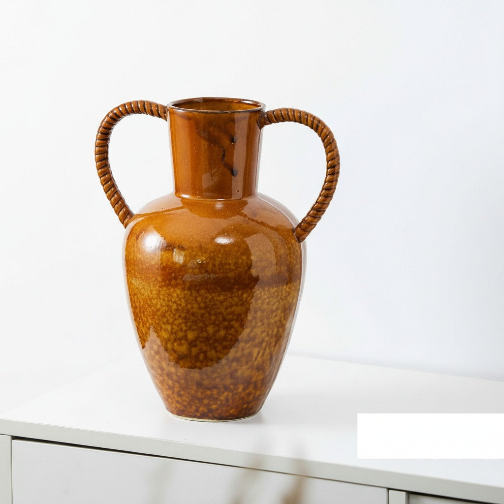 Amber glazed ceramic vase with twisted handles front view