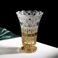 Front view of amber gradient cut glass vase with intricate patterns