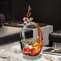 Front view of amber glass sculpture with enamel persimmon detail