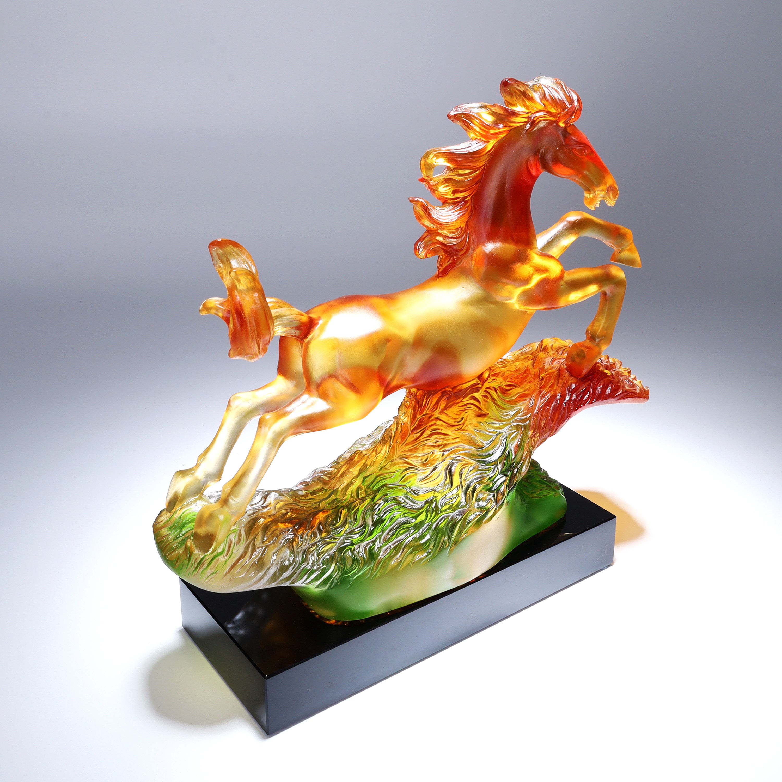 Rear view of galloping horse sculpture showing color gradient