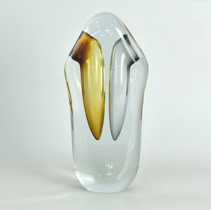 Close up detail of large amber and grey glass vase