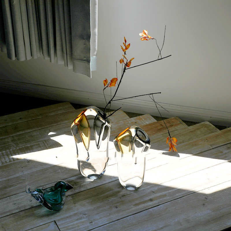 High angle view of sculptural vases casting shadows