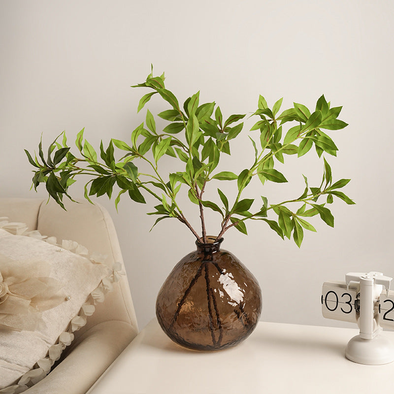 Round amber glass vase on white table