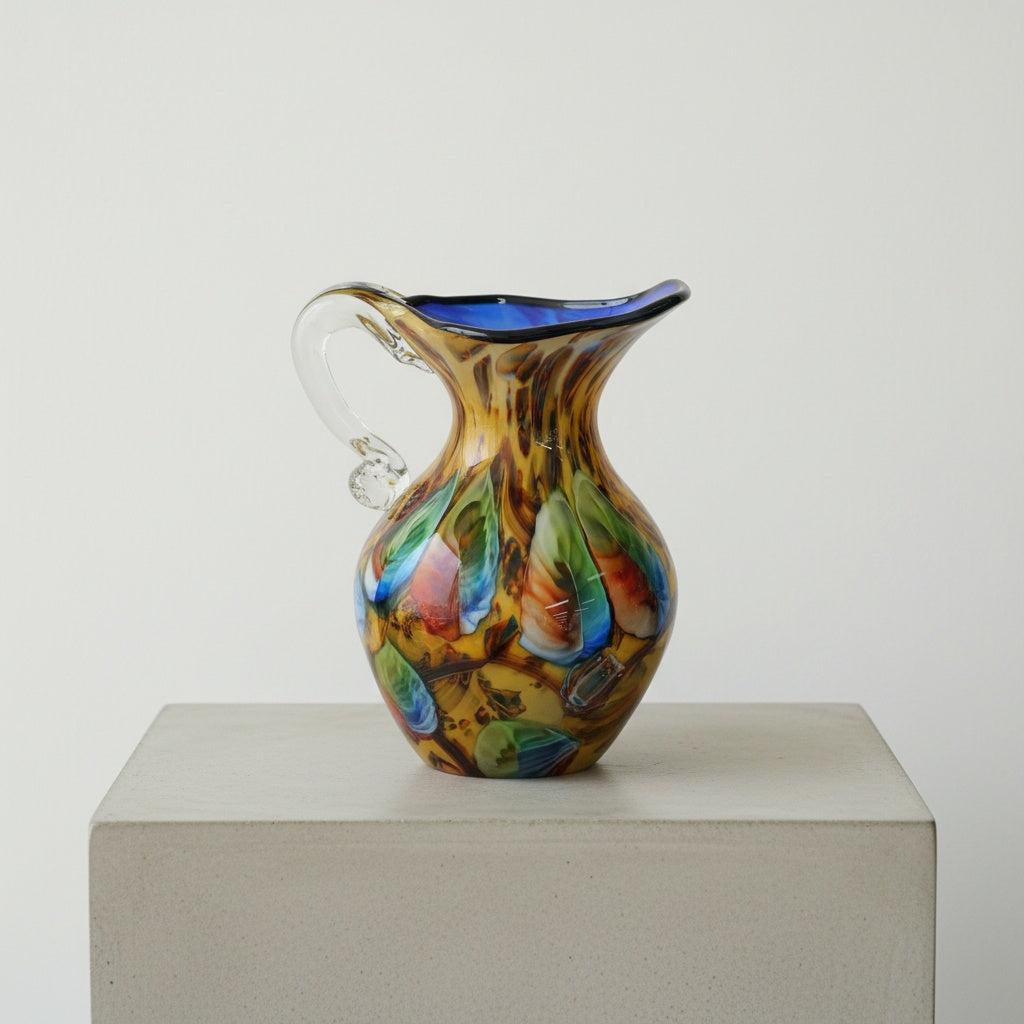 Side view of amber and multicolor glass pitcher vase