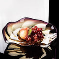 Amber and purple gradient glass bowl with fruit