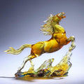 Side view of translucent amber resin rearing horse sculpture