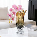 Amber and smoke gradient crystal vase with orchids on table