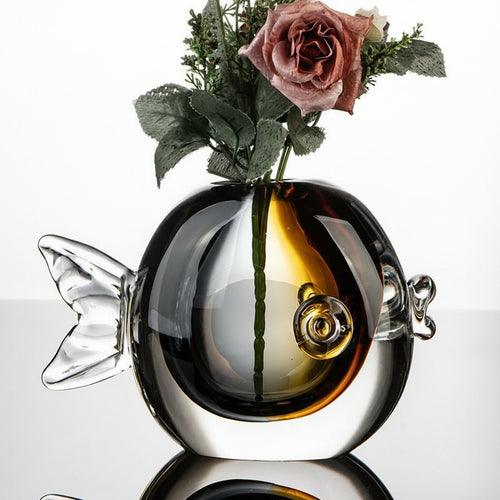 Glass fish vase styled with flowers