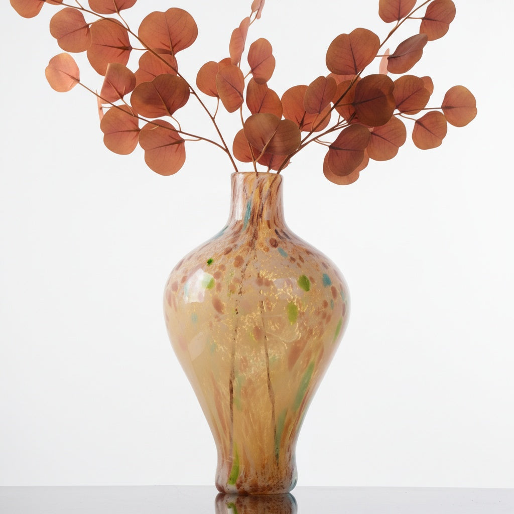 Amber art glass vase with dried eucalyptus branches