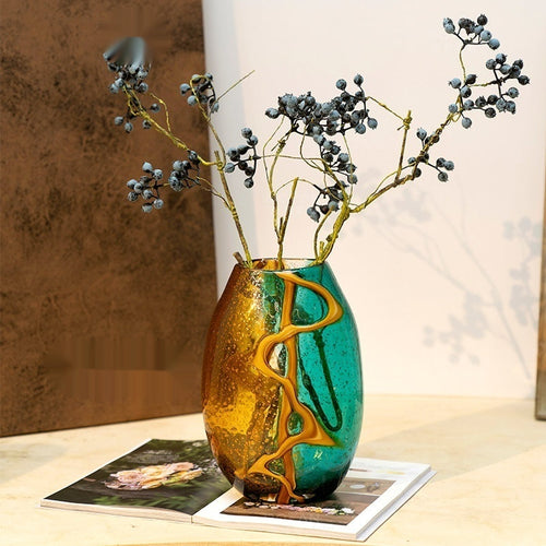 Amber and teal bubbled glass vase with dried berries