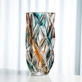 Front view of amber and teal diamond cut glass vase