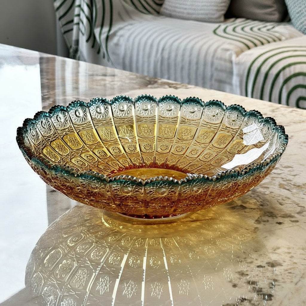 Amber and teal gradient glass bowl on marble table