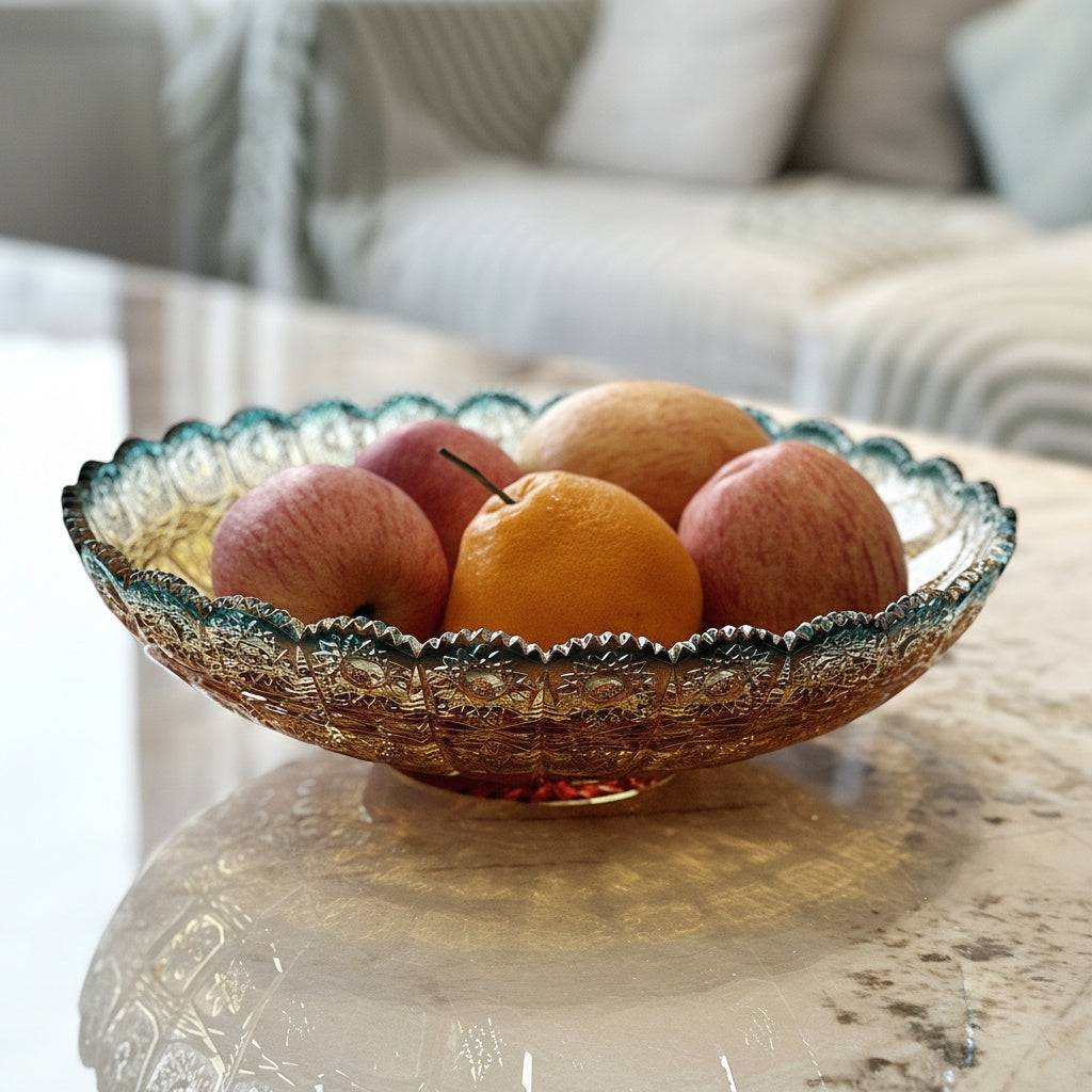 Glass fruit bowl filled with apples and oranges