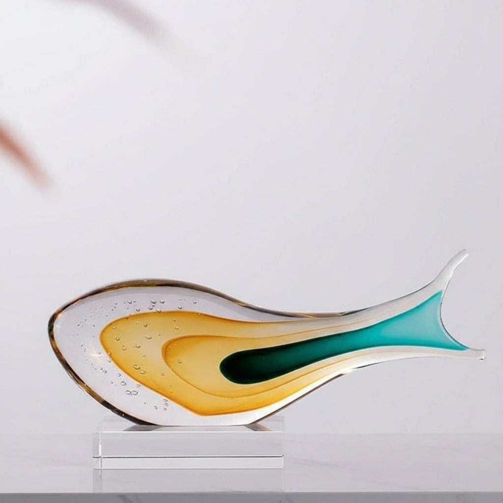Side profile of abstract glass fish on crystal base